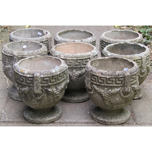 1093 - A set/run of eight small weathered composition stone garden urns with repeating Greek key fruiting v... 