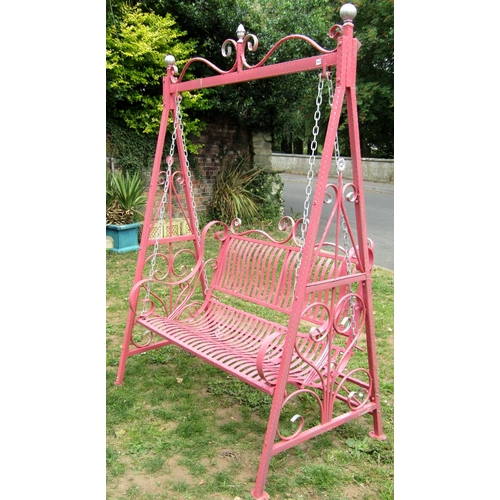 1117 - An iron work two seat garden swing with strapwork seat and back, chain hung and raised on A framed s... 