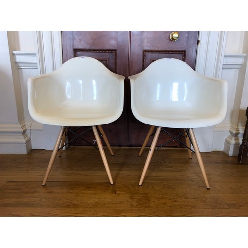 299 - A pair of DAW armchairs by Vitra after a design by Eames - in a white colourway set on beechwood sup... 