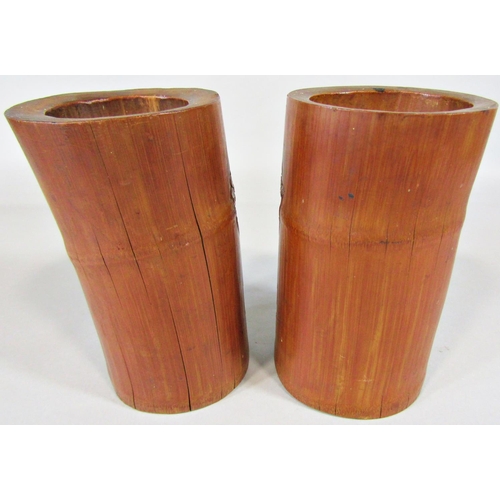 50 - A pair of carved bamboo brush pots showing characters in a landscape, 19cm tall approx