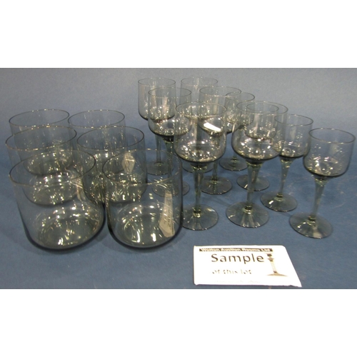 106 - Holmegaard style smoky glassware, including six tall wine glasses, six smaller aperitif glasses, fou... 