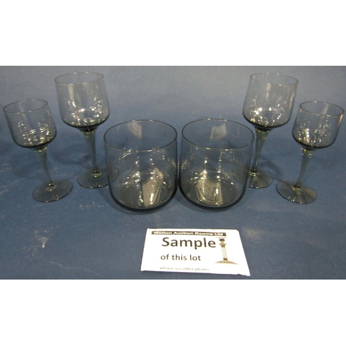 106 - Holmegaard style smoky glassware, including six tall wine glasses, six smaller aperitif glasses, fou... 