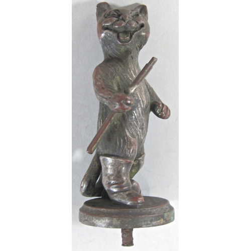 386 - An old silver plated car bonnet mascot in the form of a cat holding a bow, after Louis Wain