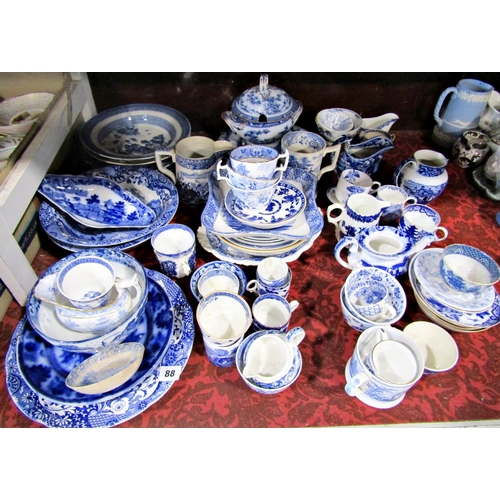 88 - A collection of 19th century and later blue and white transfer ware, cups, dishes, mugs, tureen and ... 