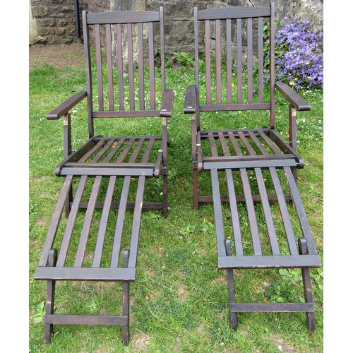 1058 - A pair of contemporary stained and weathered folding hardwood garden steamer type chairs with slatte... 