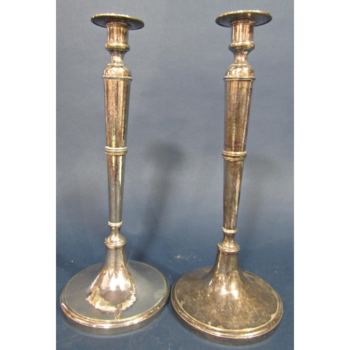 181 - A pair of slender silver arts and crafts style Guild of Handicraft candlesticks, London 1976, with l... 