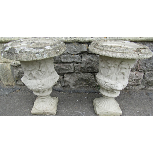 1110 - A pair of weathered cast composition stone campana shaped garden urns with flared rims, lions mask a... 