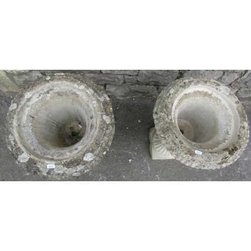 1110 - A pair of weathered cast composition stone campana shaped garden urns with flared rims, lions mask a... 