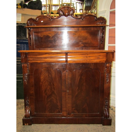 1670 - A slim Victorian mahogany chiffonier enclosed by a pair of panelled doors flanked by carved acanthus... 