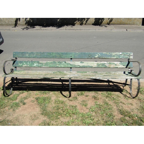 1091 - A vintage sprung steel park bench with weathered green painted timber lathes, 244cm long (8ft)