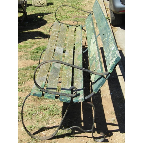 1091 - A vintage sprung steel park bench with weathered green painted timber lathes, 244cm long (8ft)