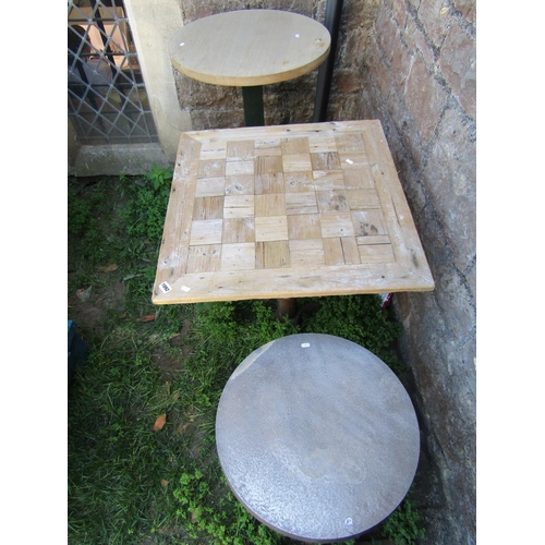 1092 - Two café or bistro tables of varying size and design, both with stripped wooden tops, together with ... 