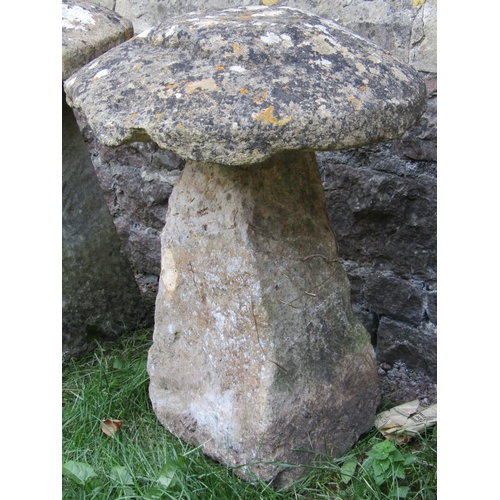 1063 - A weathered natural stone staddlestone of square tapered form with domed cap, approx 60cm diameter x... 