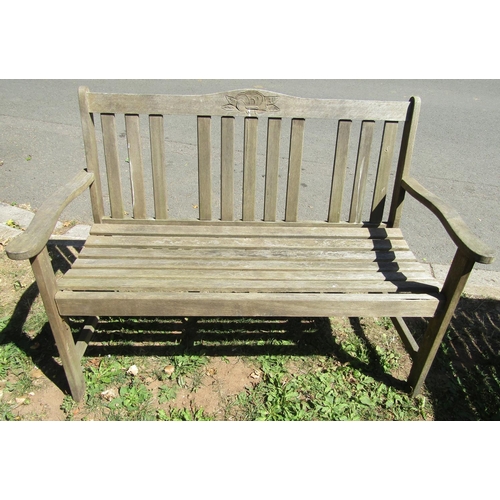 1076 - A weathered hardwood garden table of rectangular form with slatted panelled top, raised on square cu... 