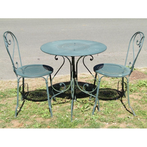 1078 - A green painted ironwork three piece terrace or bistro set comprising circular top table with decora... 