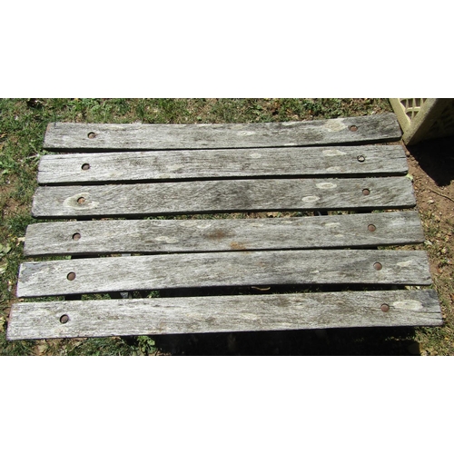 1079 - A vintage sprung steel garden bench  with weathered timber lathes, 150cm wide, together with a match... 