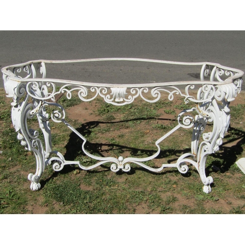 1082 - A good quality cream painted ironwork conservatory or garden table with serpentine outline, raised o... 