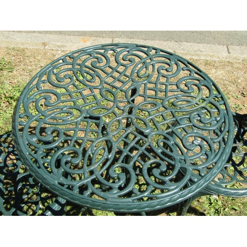 1089 - A green painted cast aluminium three piece garden terrace set with decorative pierced and scrolling ... 