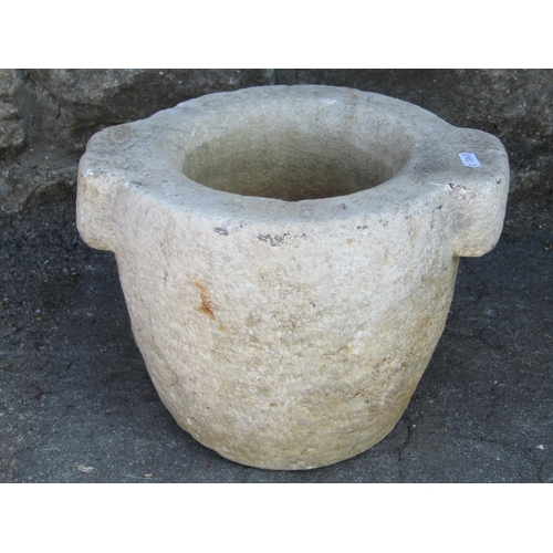 1109 - A carved natural stone mortar with pronounced lugs, 31 cm diameter (overall size) x 23 cm high