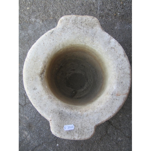 1109 - A carved natural stone mortar with pronounced lugs, 31 cm diameter (overall size) x 23 cm high