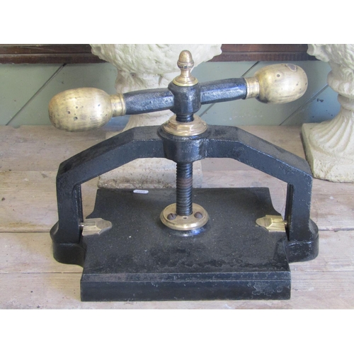 1111 - An antique cast iron book press with central screw thread, club handle, acorn finial, brass/possibly... 