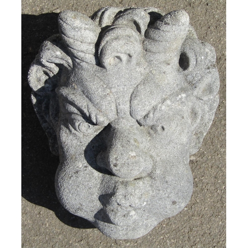 1112 - A weathered stone satyr wall mask with well defined features 28 cm high x 22 cm  wide