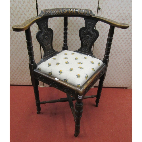 1653 - A mid-Victorian period Gothic revival corner chair with carved detail and drop in seat, the top rail... 