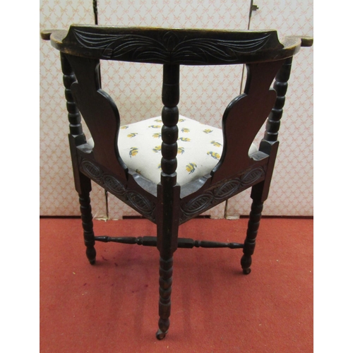 1653 - A mid-Victorian period Gothic revival corner chair with carved detail and drop in seat, the top rail... 