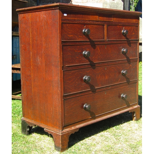 1633 - A late Georgian oak chest of three long and two short graduated drawers, crossbanded in walnut, rais... 