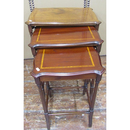 1635 - A graduated set of three Edwardian mahogany occasional tables, crossbanded in satinwood, on tapering... 