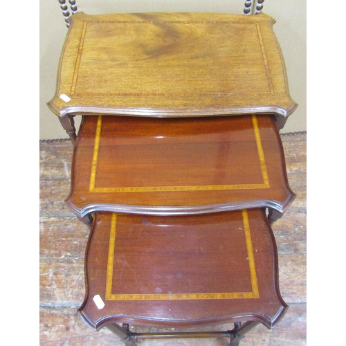 1635 - A graduated set of three Edwardian mahogany occasional tables, crossbanded in satinwood, on tapering... 