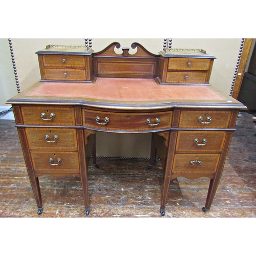 1652 - An inlaid Edwardian mahogany ladies writing desk, bowfronted centre flanked by six drawers, on squar... 