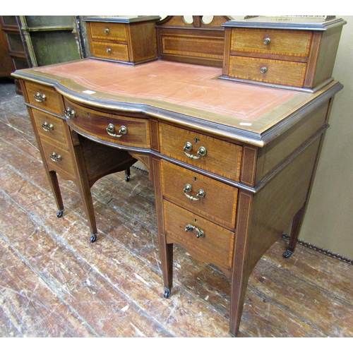 1652 - An inlaid Edwardian mahogany ladies writing desk, bowfronted centre flanked by six drawers, on squar... 