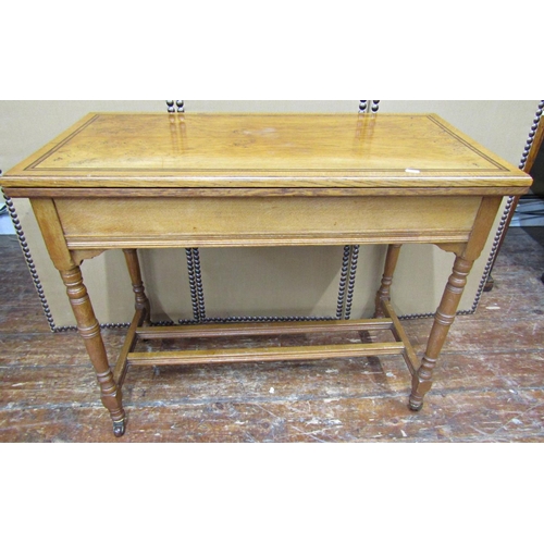 1656 - A Victorian pale oak foldover top card table of rectangular form with baize lining, set on four turn... 