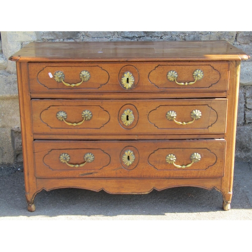 1657 - A late 18th century French provincial walnut commode of three drawers, with original brass fittings,... 