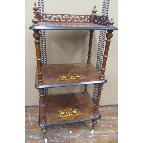 1658 - A Victorian figured walnut three tier watnot, with turned supports, 105cm high