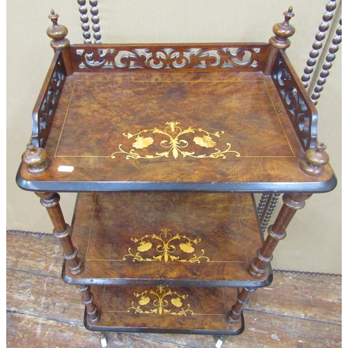 1658 - A Victorian figured walnut three tier watnot, with turned supports, 105cm high