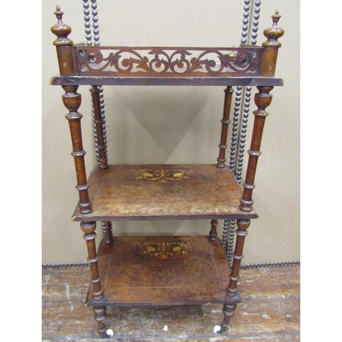 1658 - A Victorian figured walnut three tier watnot, with turned supports, 105cm high