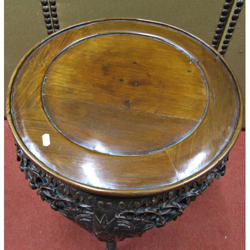 1660 - A 19th century Chinese hardwood occasional table, the circular top raised on four carved supports, u... 