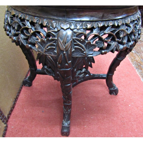 1660 - A 19th century Chinese hardwood occasional table, the circular top raised on four carved supports, u... 