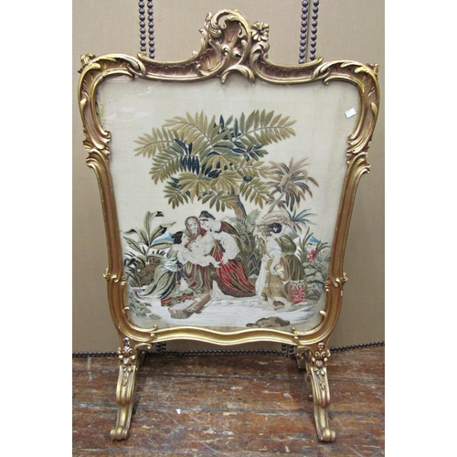 1661 - A substantial 19th century firescreen or divider, the carved and gilded framework on scrolled suppor... 