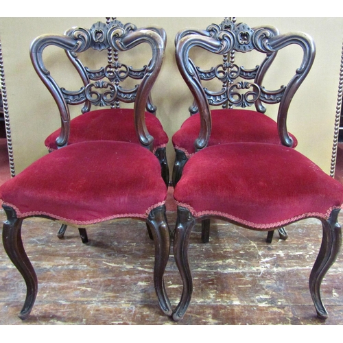 1664 - A set of four early Victorian mahogany dining chairs with shaped moulded and pierced backs, serpenti... 