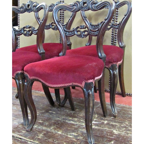 1664 - A set of four early Victorian mahogany dining chairs with shaped moulded and pierced backs, serpenti... 