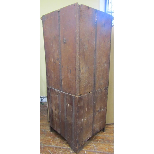 1665 - A Georgian oak free standing corner cupboard, the lower section enclosed by a pair of panelled doors... 