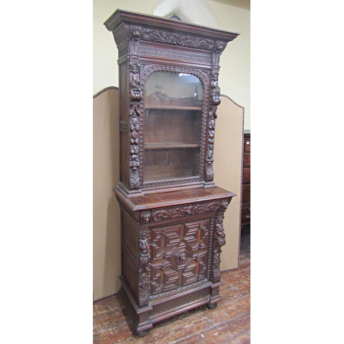 1666 - A mid-19th century gothic oak revival pier cabinet, the lower section enclosed by a panelled door wi... 