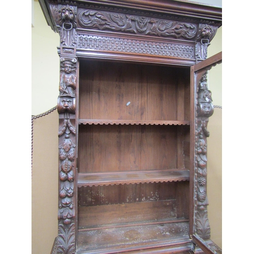 1666 - A mid-19th century gothic oak revival pier cabinet, the lower section enclosed by a panelled door wi... 