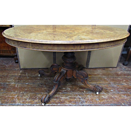 1668 - A Victorian walnut and burr walnut loo table, the oval top quarter panelled and raised on a carved p... 