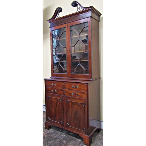 1675 - A Georgian mahogany secretaire bookcase, the lower section enclosed by a pair of panelled doors, the... 