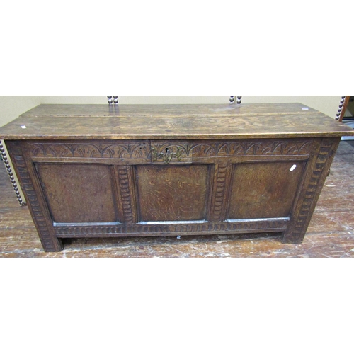 1678 - An old English oak coffer with panelled framework and repeating carved detail, 117cm wide