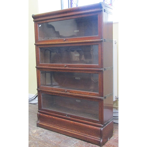 1663 - A Globe Wernicke four tier oak bookcase with glazed up and over doors